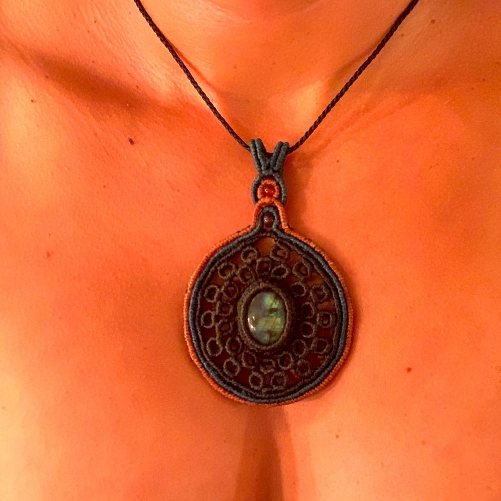 Handwoven, adjustable necklace. Center stone is a greenish-blue.